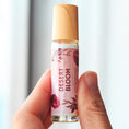 Load image into Gallery viewer, Cedar Mountain Candle Desert Bloom roll-on perfume oil with floral and wood notes in a 10ml glass bottle with bamboo lid.