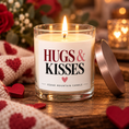 Load image into Gallery viewer, Lit Hugs & Kisses candle beside a rose gold lid
