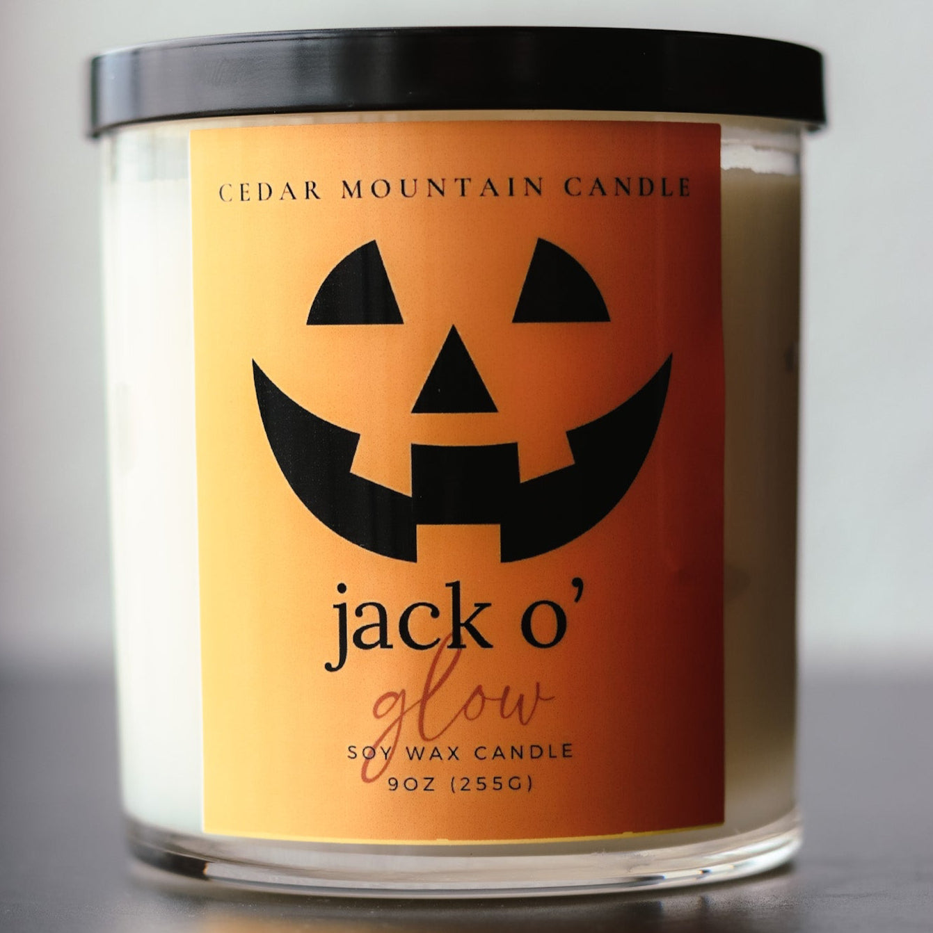 Halloween Candle with Jack O Lantern Face on the Label scented in sweet cinnamon