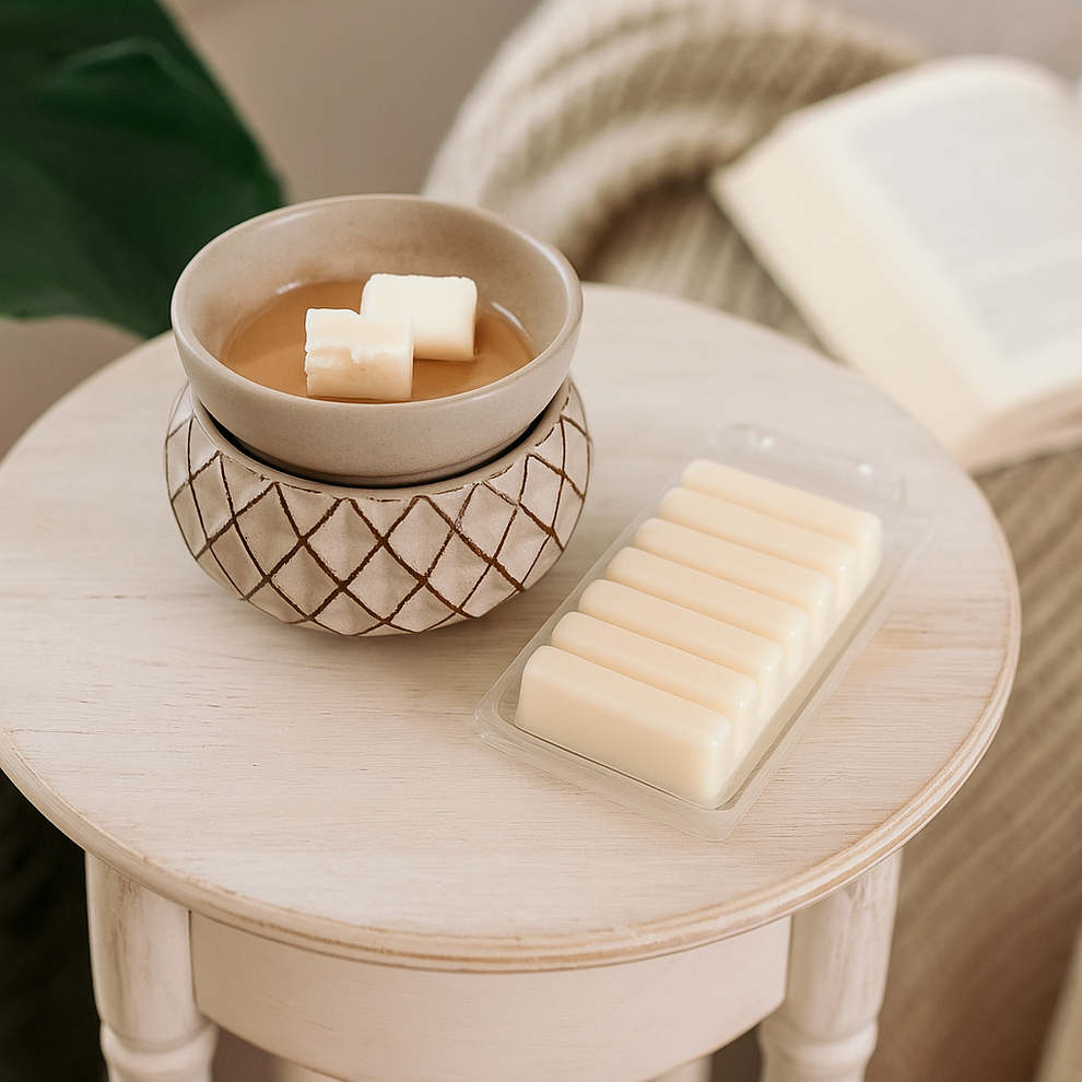ceramic wax warmer with cubes of wax in it on a wooden table