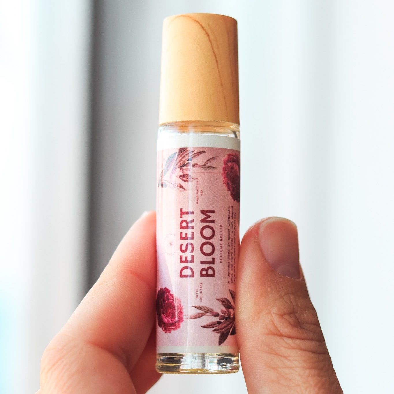 Cedar Mountain Candle Desert Bloom roll-on perfume oil with floral and wood notes in a 10ml glass bottle with bamboo lid.