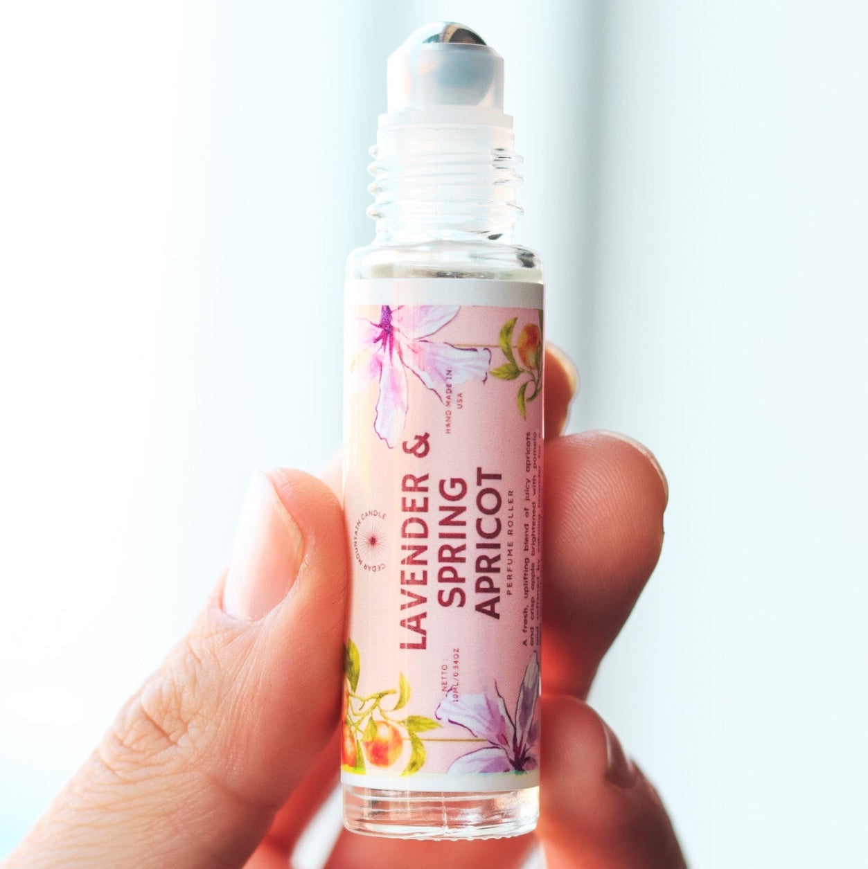 Cedar Mountain Candle Lavender & Spring Apricot Perfume Roller with floral and fruit design. Portable glass bottle with rollerball.