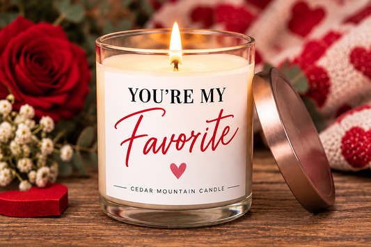 Lit You're My Favorite candle beside roses and a rose gold lid